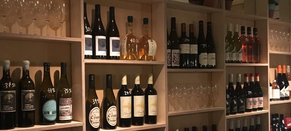 Shelves full of wine bottles and wine glasses